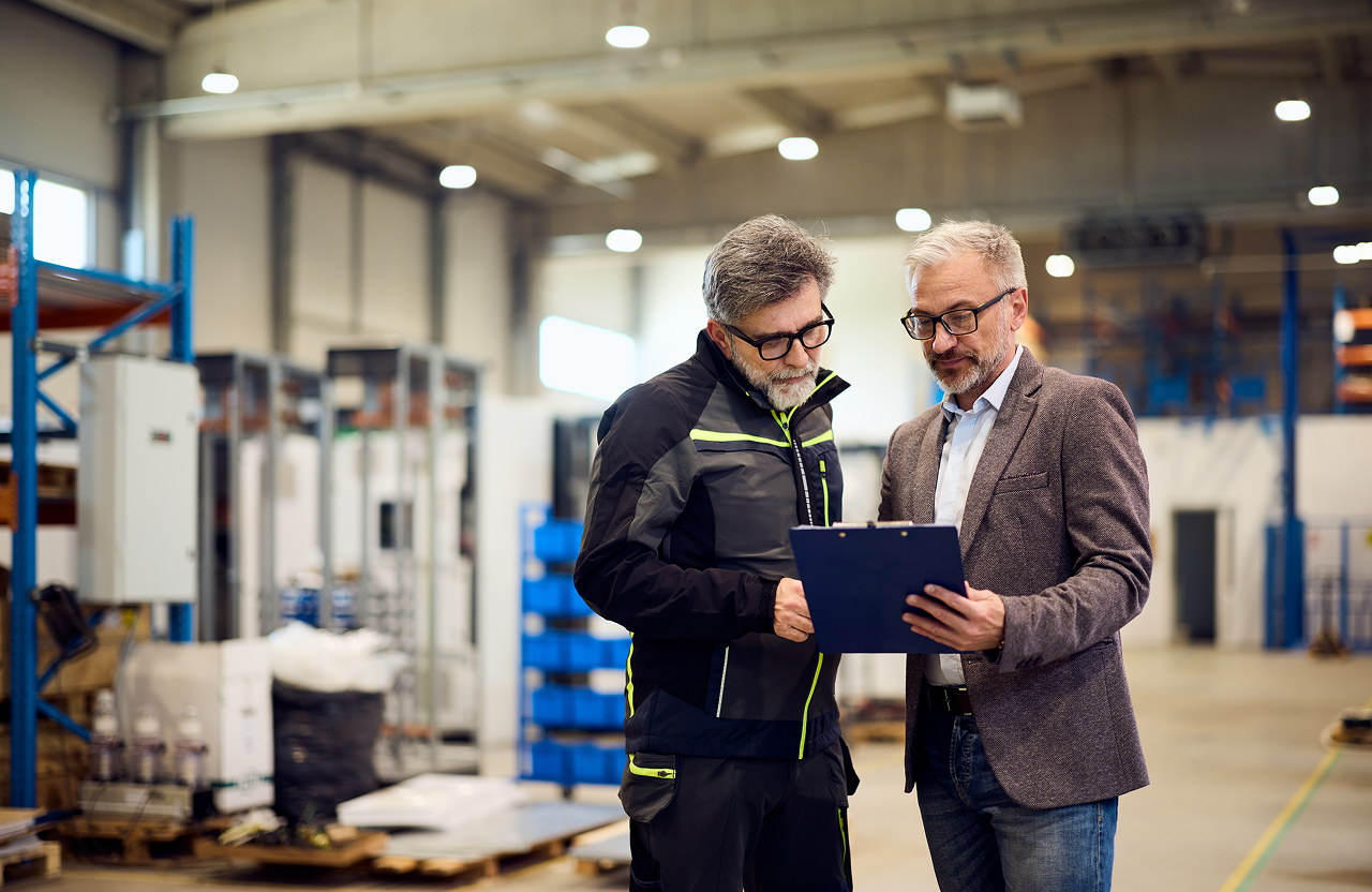 image of two manufacturing employees meeting