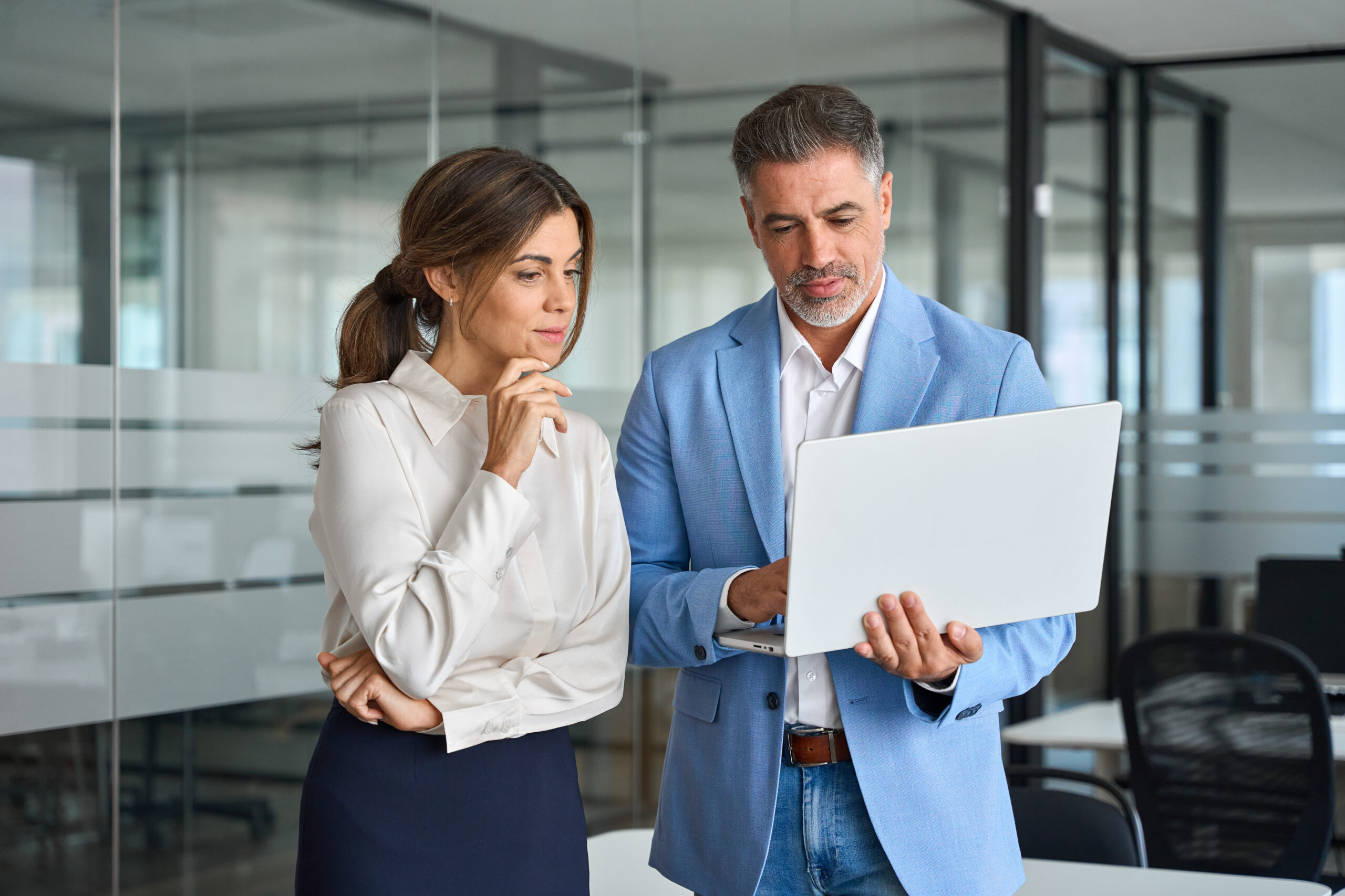 manufacturing employee showing his laptop to a sales team member